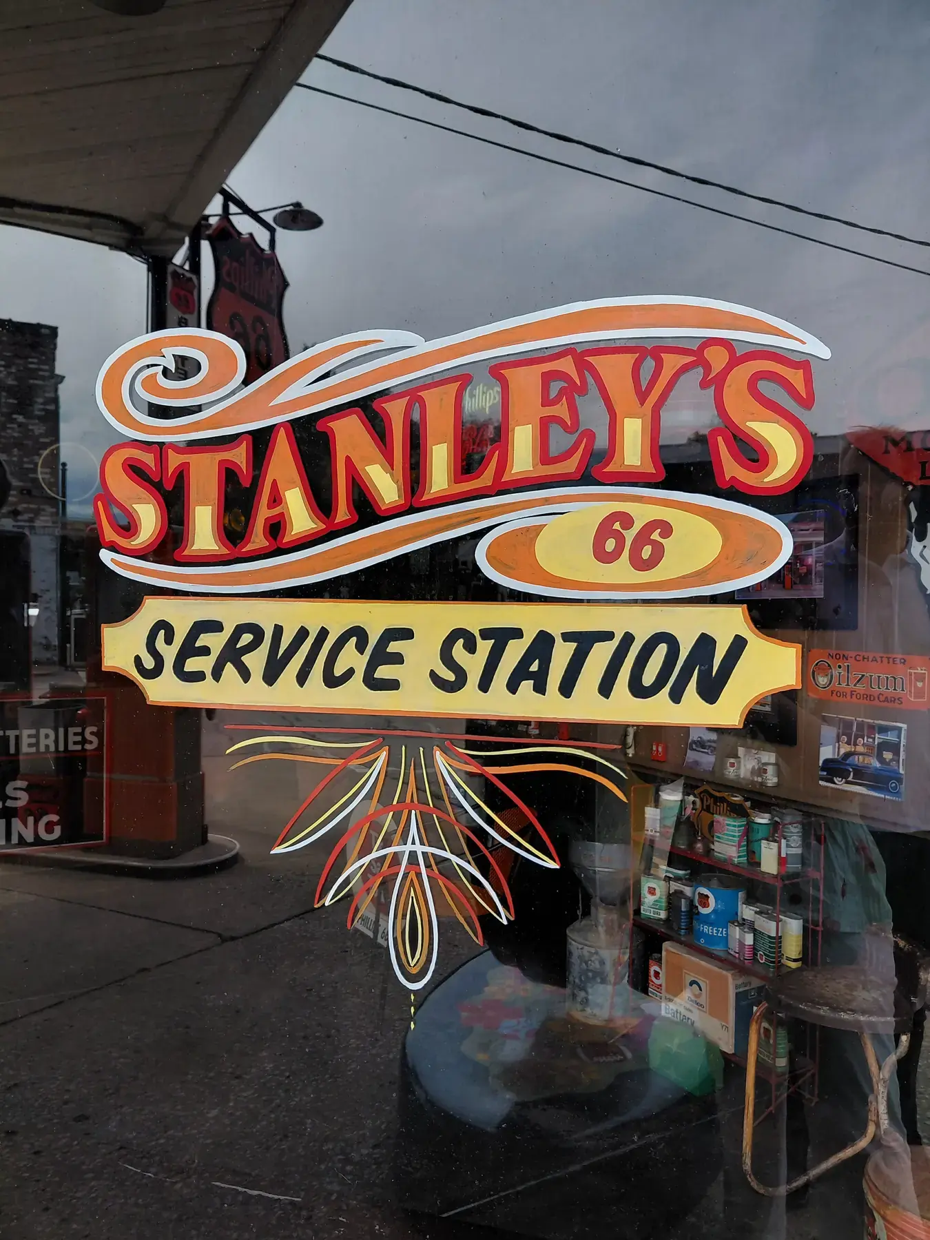Hand-painted vintage service station lettering on a shop window